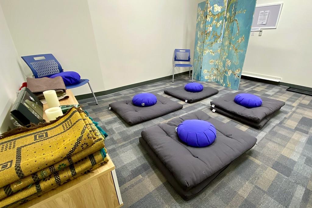 Interior shot of the Interfaith Prayer and Reflection Room including floor pillows and blankets